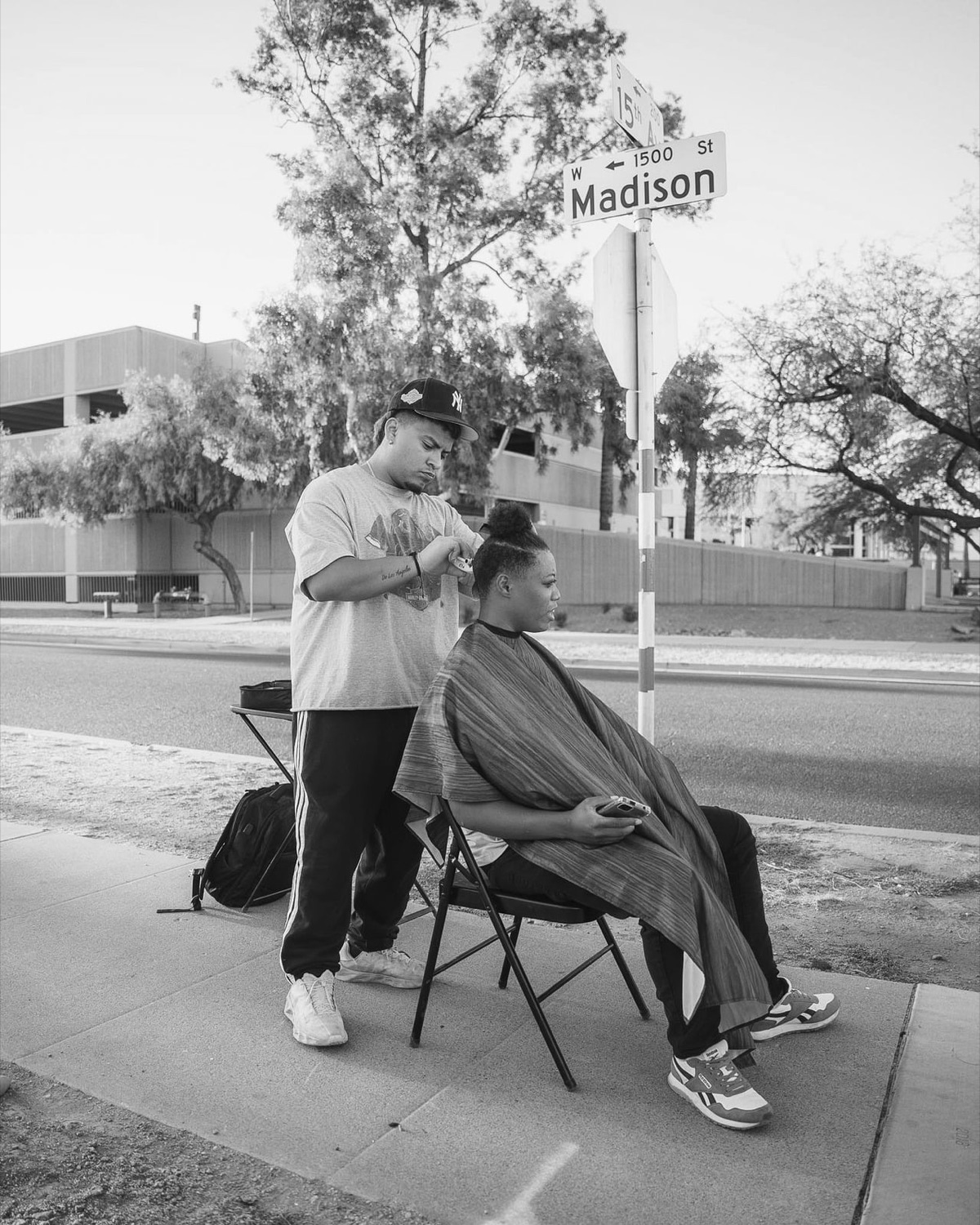 A free haircut being given on the street